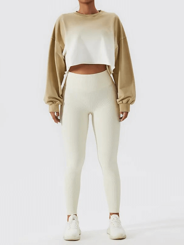 Model wearing beige and white long sleeve crop top with matching leggings, showcasing sporty and stylish activewear